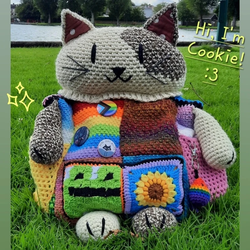 [Cookie the Cat-Backpack, chilling on the grass in Ireland.]